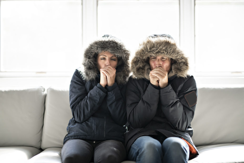 A couple trying to stay warm after their home heating system failed