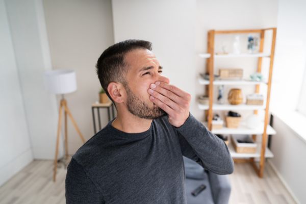 Man holding his nose because of smelly HVAC