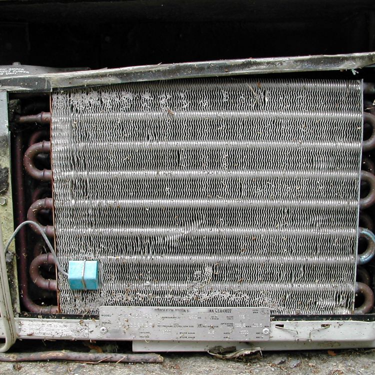 Photo of a dirty HVAC condenser