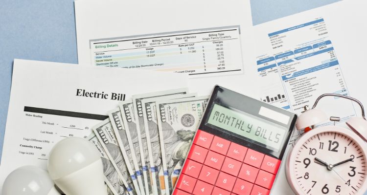 Photo of energy bills with money and a calculator