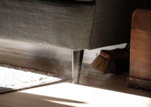 photo of broom sweeping dust on a floor